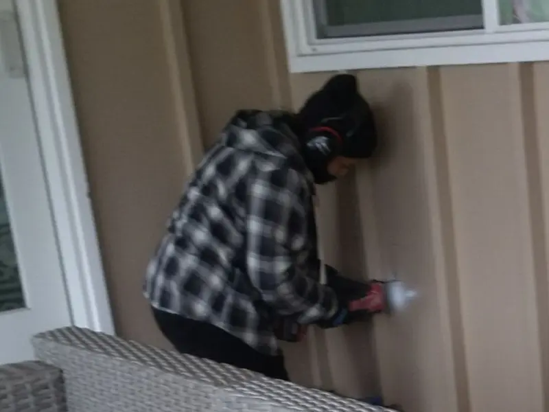 Professional electrician installing an exterior outlet in St. Rose
