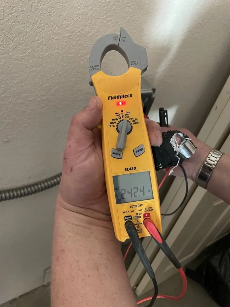 Voltage testing with clamp meter during Ceiling Fan Installation in St. Rose